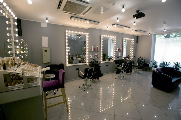 Elegant beauty salon interior with modern styling stations and luxurious ambiance